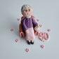 Edible fondant figurine sitting in the armchair cake decoration