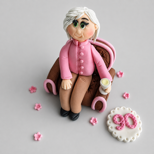 Edible fondant figurine sitting in the armchair cake decoration